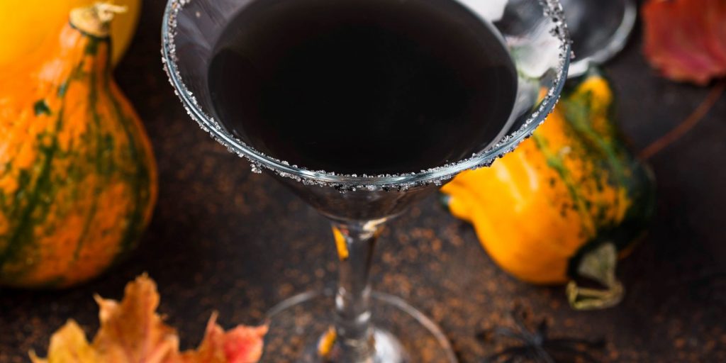 Spooky Halloween Black Magic cocktail with pumpkins