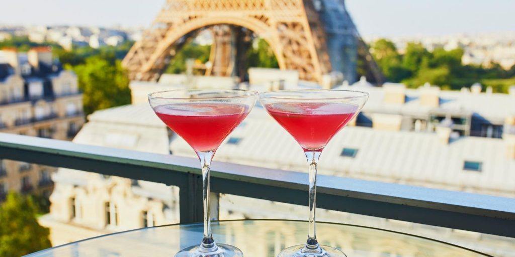 Two French martini on an outdoor table facing the Eiffel Tower