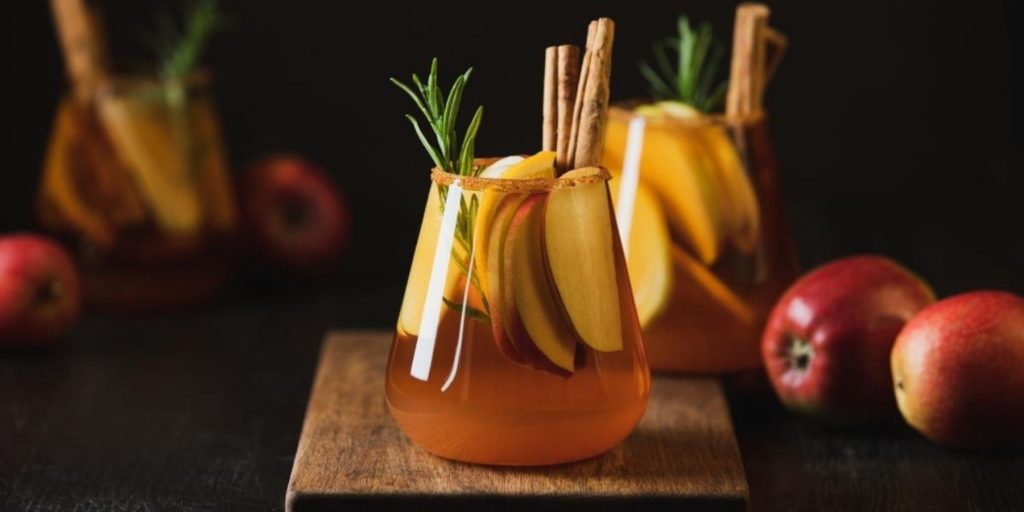 Apple Butter Old Fashioned in tumbler with apple slices and cinnamon sticks