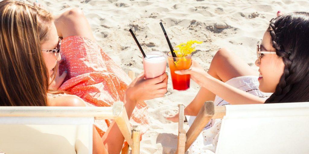 Friends enjoying cocktails on the beach