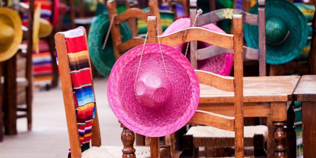 Bright pink sombrero hanging from a chair