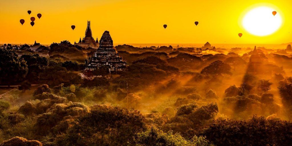 Skyscape of Myanmar at sunrise with hot air balloons in the background 