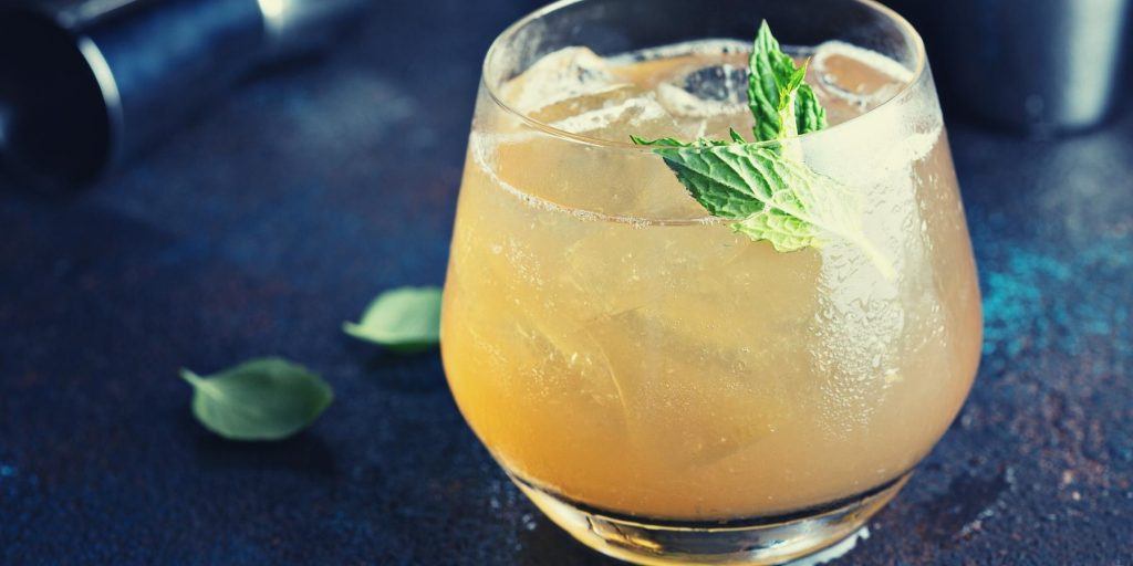 Low alcohol apple cocktail garnished with mint