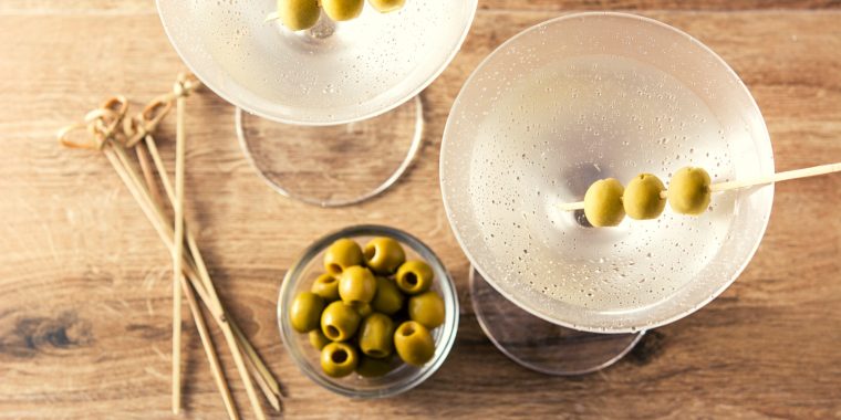 Top view of classic Martinis with green olive garnish