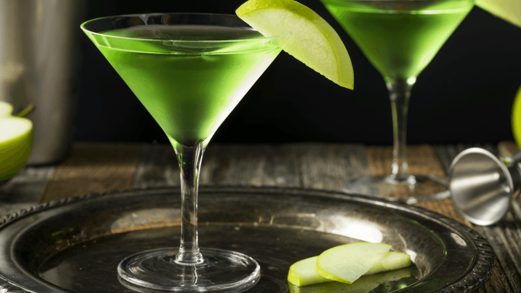 Homemade Green Alcoholic Appletini Cocktail with Apple Garnish