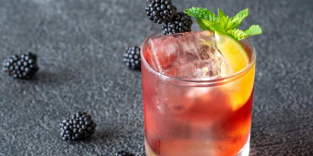Sip on the refreshing Blackberry Gin Smash, a delightful fusion of gin, muddled blackberries, and a splash of citrus.