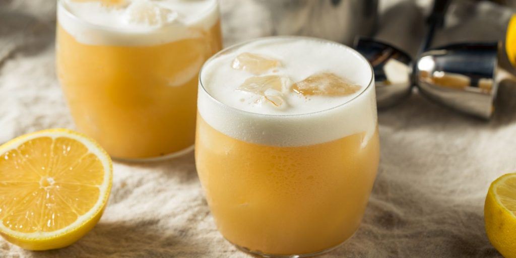 Close up front view of two Tequila Sours on a white cloth surface