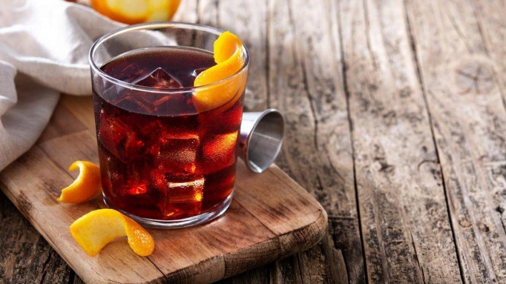 Cognac and coffee liqueur on the rocks, garnished with orange peel