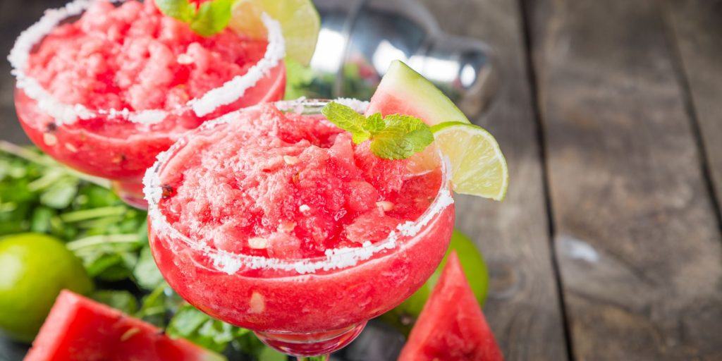 Two frozen watermelon margaritas with lime
