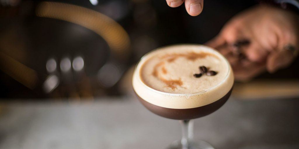 Close up top shot of a creamy Espresso Martini garnished with three coffee beans