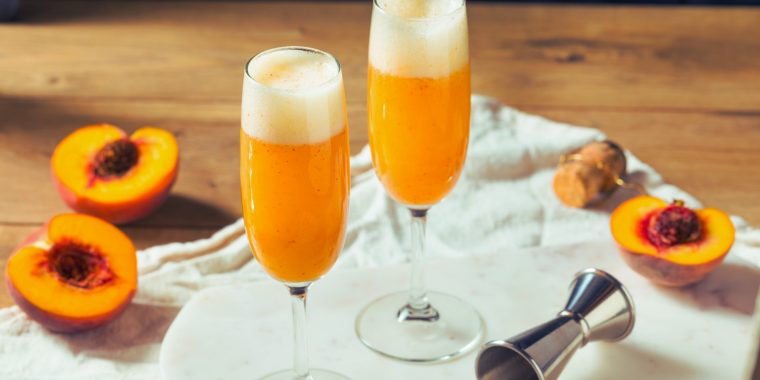 Peach Bellini cocktails served in flute glasses