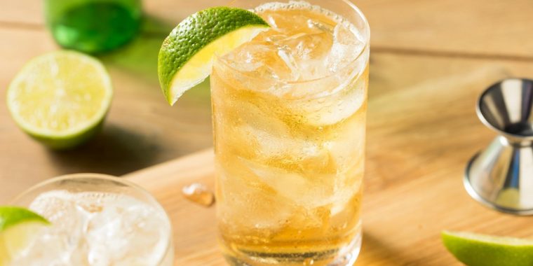 Close-up of Rock Shandy in Highball glass filled with ice and garnished with lime wedge