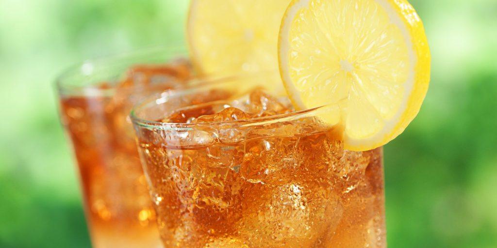 Close up front view of a pair of Arnold Palmer Mocktails garnished with lemon wheels