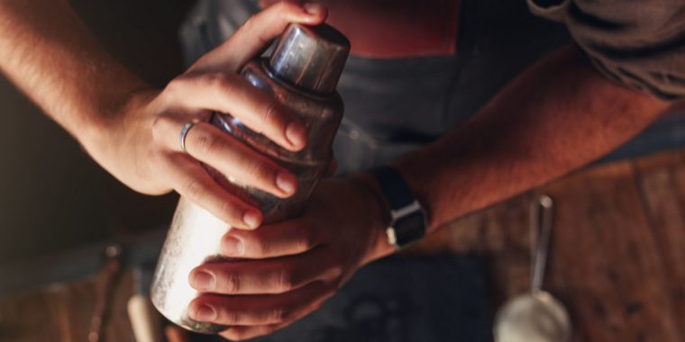Bartender close up shaking a Cobbler shaker