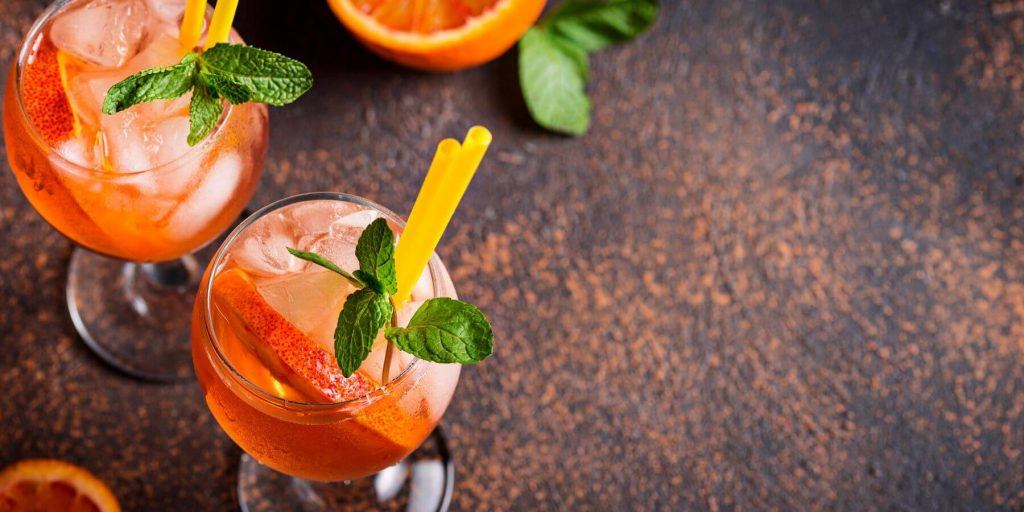 Aperol Orange Juice cocktail shown from above with mint