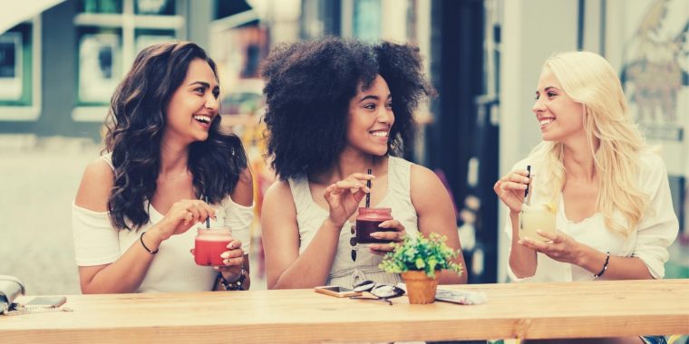 Friends enjoying cocktails at a Parisian street cafe