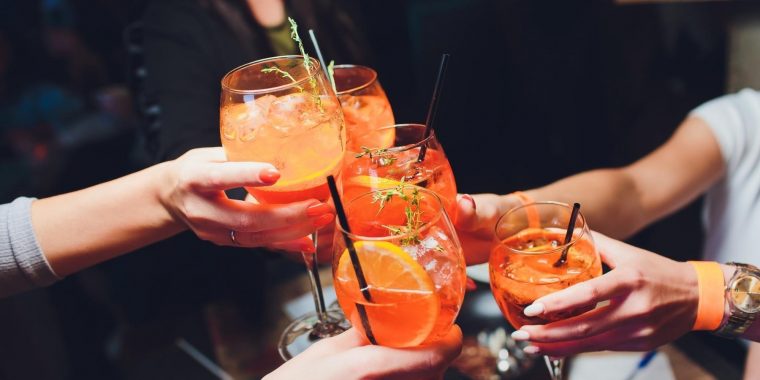 Friends clinking low alcohol cocktails together