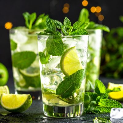 Close-up of three Virgin Mojitos with fresh mint and lime garnish