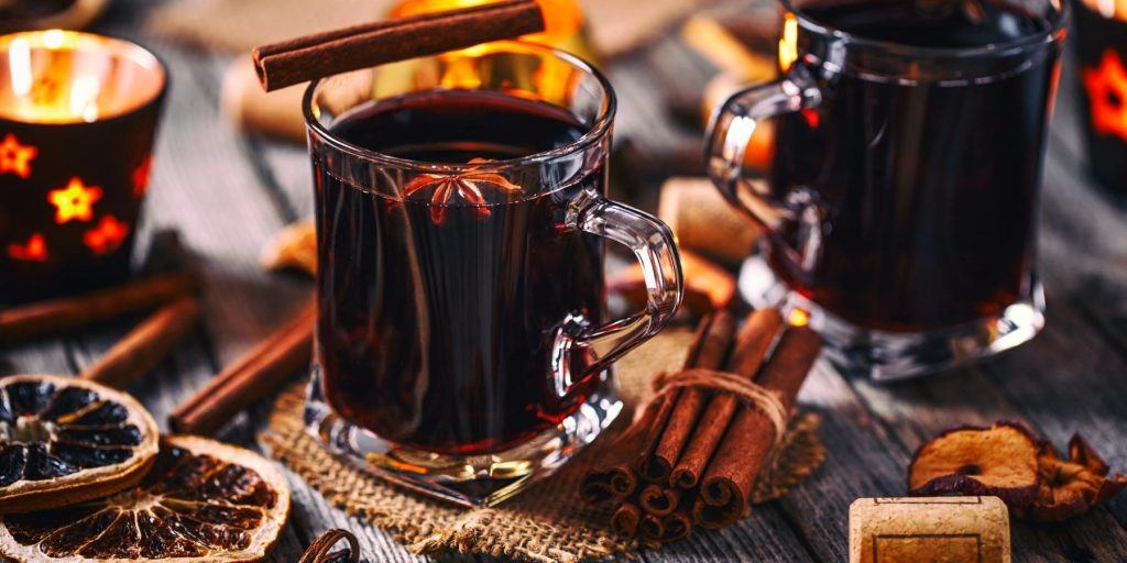 Mugs of mulled wine with cinnamon and orange