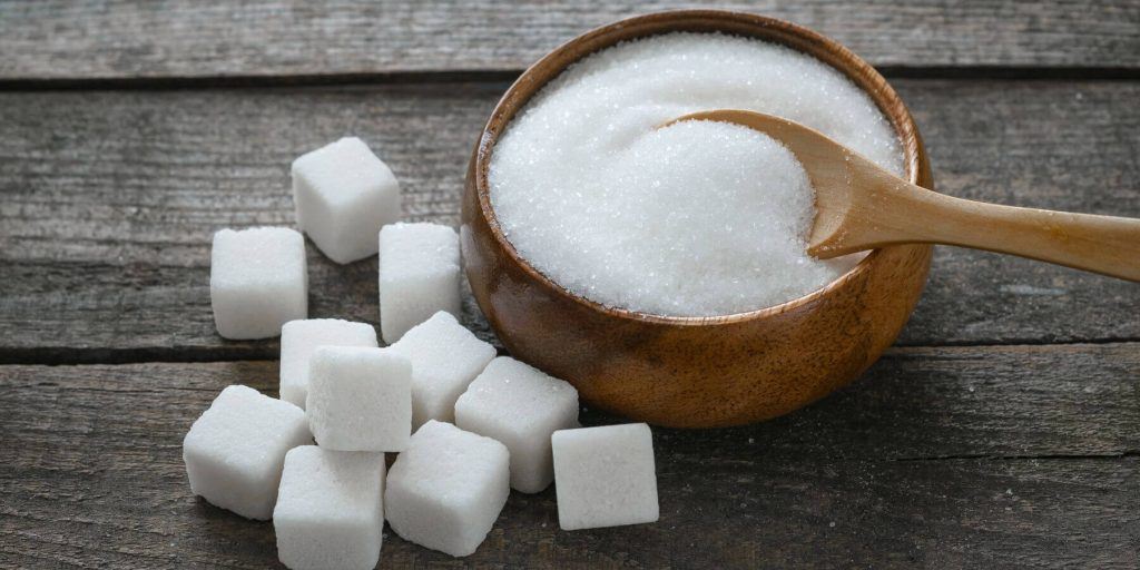 Granulated sugar in a wooden bowl