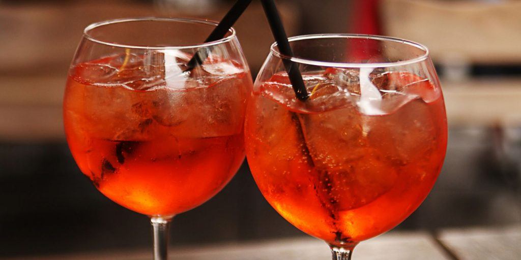 Two Campari Spritz with black straws
