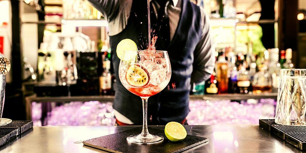 Front shot of bartender pouring a cocktail