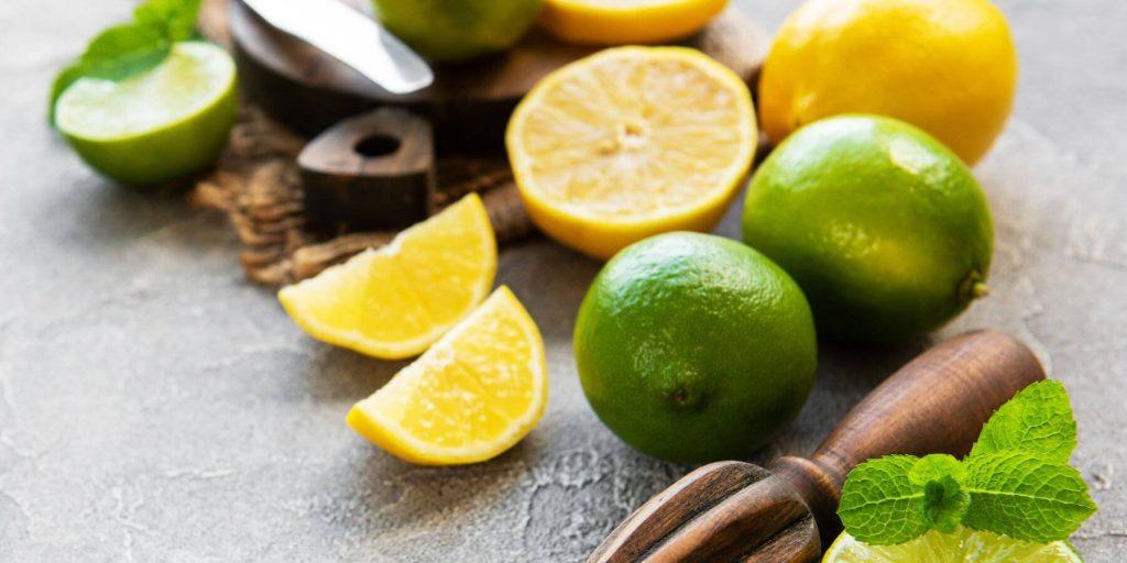 Lemons and limes on a board