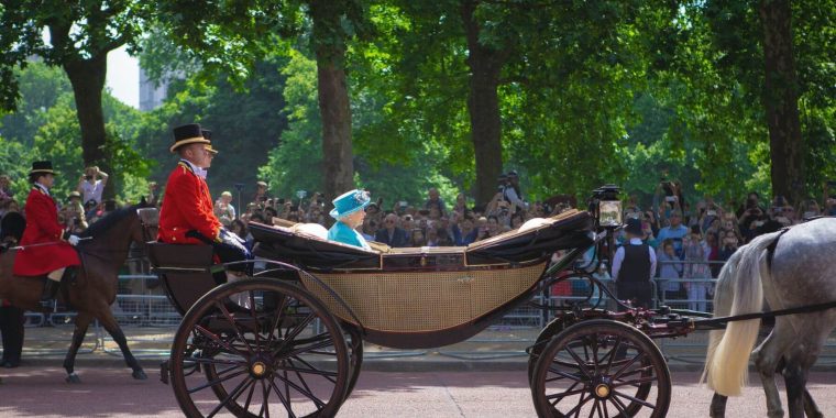 The Queen in a carriage on a sunny day