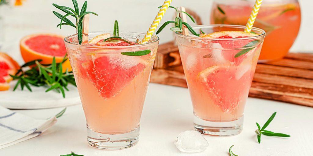 Vodka and grapefruit drinks with rosemary garnish