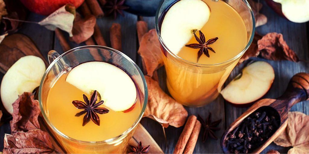 Hot apple cider and rum with star anise and apple garnish