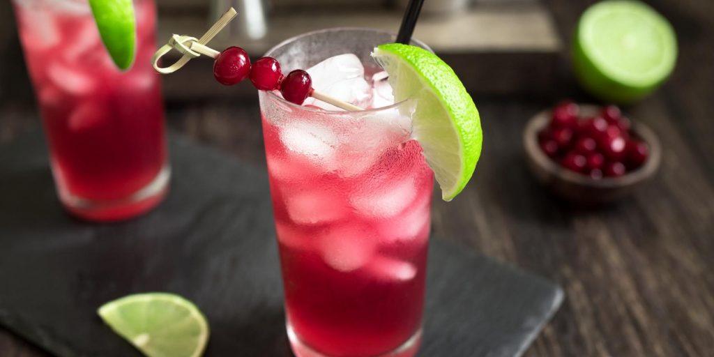 Rum and cranberry juice with lime garnish