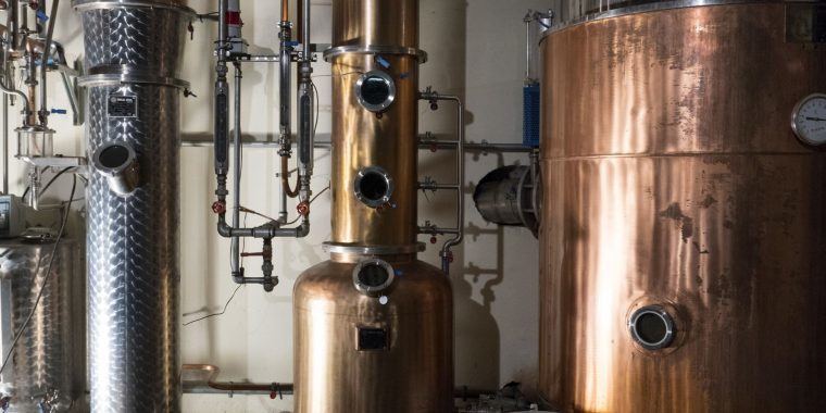 Origins of Gin - A glimpse inside a distillery, showcasing the origins of gin production.