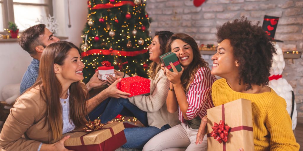 Friends exchanging Christmas gifts