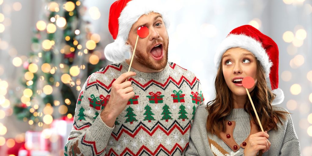 A couple in ugly Christmas sweaters