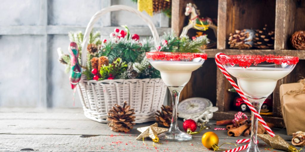 Two Christmas themed cocktails with candy canes