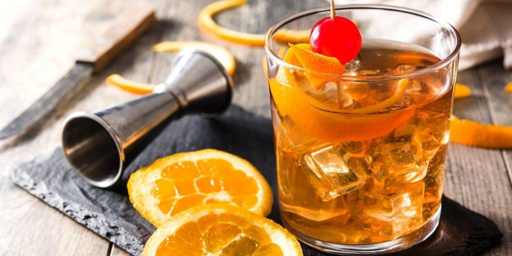 An Old Fashioned cocktail, a classic mix of bourbon, sugar, and bitters, served over ice.