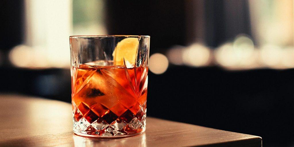 Aperol Negroni with a lemon wedge