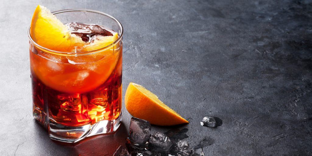 An Americano cocktail with orange garnish