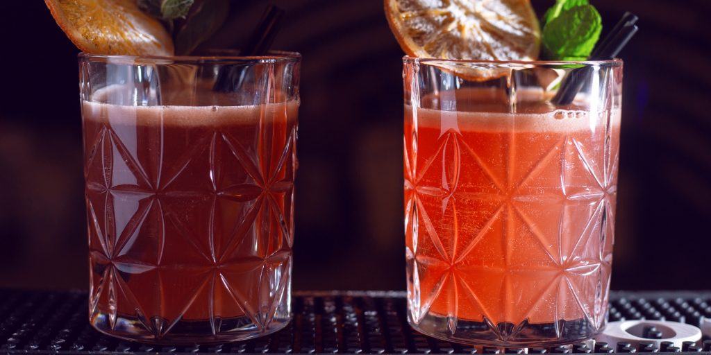 Two Cranberry Whiskey Sour cocktails