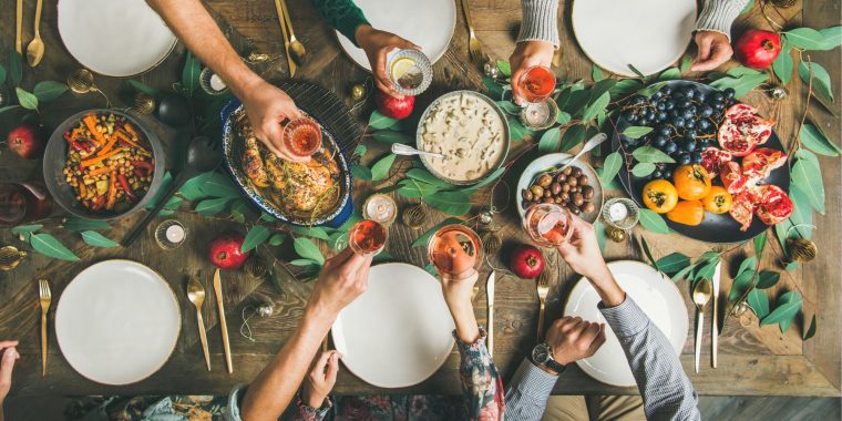 A festive table with a group of friends toasting