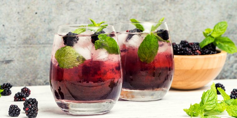 Blackberry shrub cocktails with mint garnish