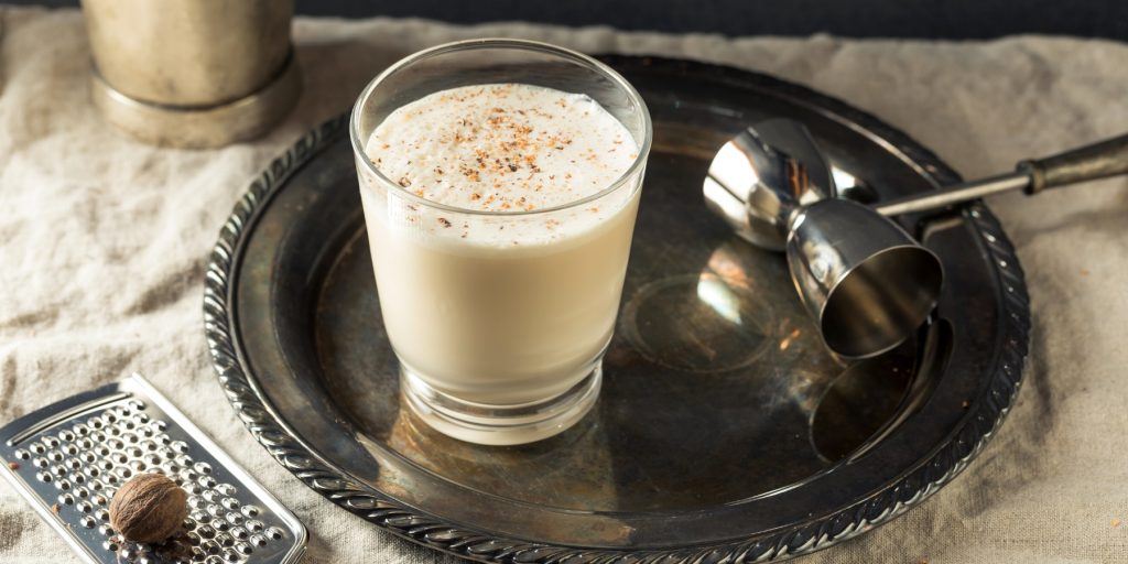A Brandy Milk Punch cocktail, a creamy blend of brandy, milk, and a hint of nutmeg.