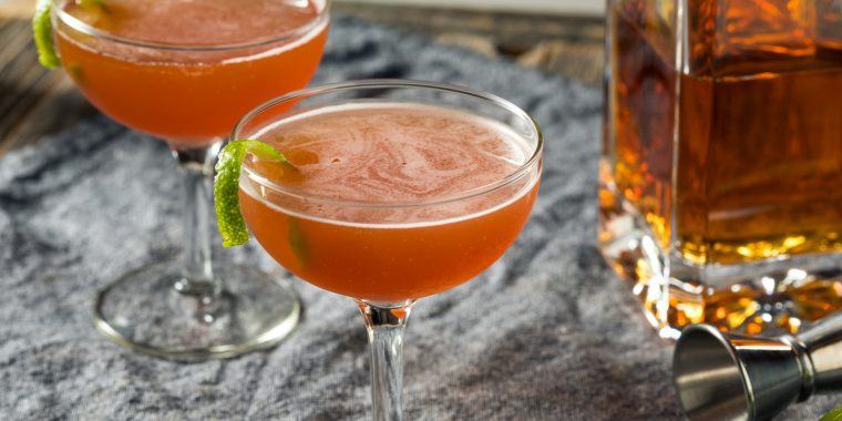 Two cognac cocktails with a twist of lime