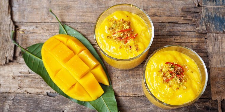 Two Mango Lassi cocktails with fresh mango