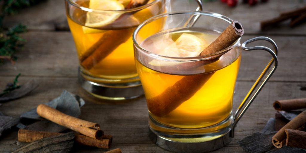 Two Indian Hot Toddies with cinnamon sticks