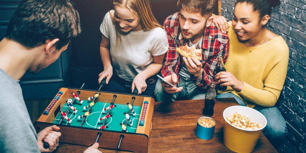 Friends playing foosball 