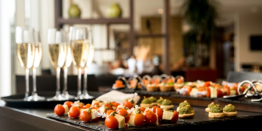 A table of Champagne and cocktail appetizers