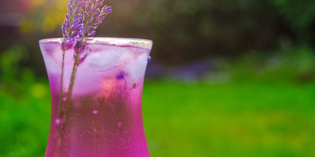 A purple-hued Floral Daiquiri cocktail garnished with lavender