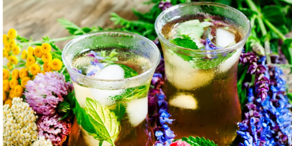 Two Green Tea Sangria cocktails surrounded by bright springtime blooms