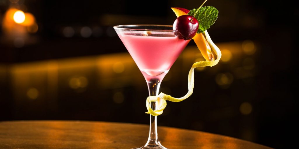 A frontal view of the Mary Pickford cocktail made with white rum, fresh pineapple juice, grenadine, and Maraschino liqueur against a dark backdrop